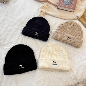 Distressed knit beanies with fox embroidery in navy, cream, black, and tan colors