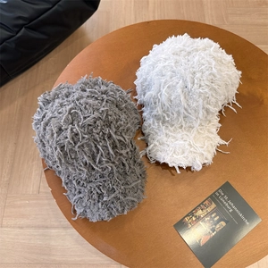 Furry tassel baseball caps in gray and white with fluffy faux fur for winter style