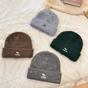 Distressed knit beanies with fox embroidery in gray, brown, and dark green colors