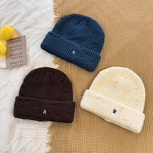 Distressed knit beanie with embroidered R letter in navy blue, brown and beige colors
