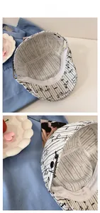Close-up of striped canvas flat cap showing internal sweatband and adjustable metal button