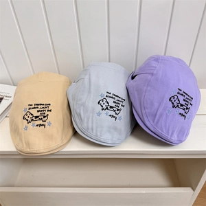 Three embroidered cotton flat caps in beige, blue and purple with dog and star patterns