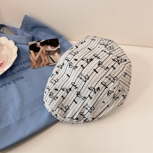 Off-white striped beret hat with cartoon dog prints in a vintage 45-degree lifestyle view