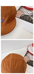Detail of tan quick-dry baseball cap featuring durable stitching and triangle patch