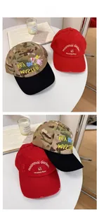 Detail view of red and camouflage baseball caps with intricate floral and letter embroidery