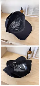 Detail of adjustable metal buckle and inner construction of black distressed baseball cap