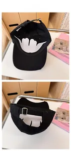 Detail view of distressed black baseball cap with vintage embroidery and metal buckle