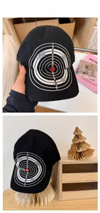 Detailed view of black distressed baseball cap featuring embroidered target pattern