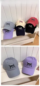 Detail view of cotton baseball caps with leopard cat embroidery in various colors