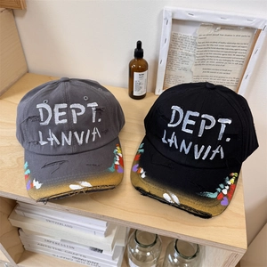 Graffiti distressed baseball cap with hand-painted splatters and torn street style detail