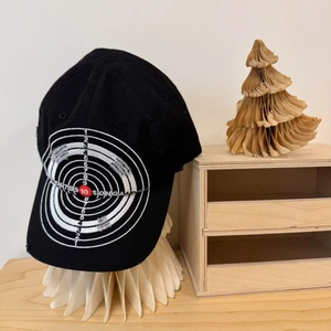 Distressed black cotton baseball cap featuring vintage target embroidery and worn details