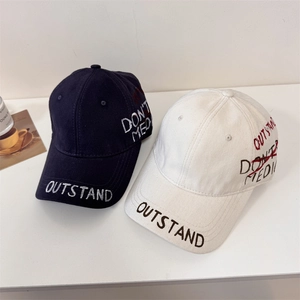 Retro washed baseball caps in navy and cream with OUTSTAND embroidery and street style