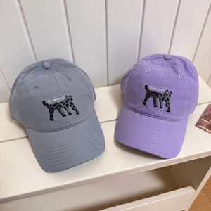Blue and purple cotton baseball caps with cat embroidery and OooW-Hoo! text on bench