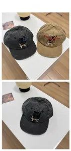 Detail of washed cotton baseball caps in charcoal and khaki with dog embroidery
