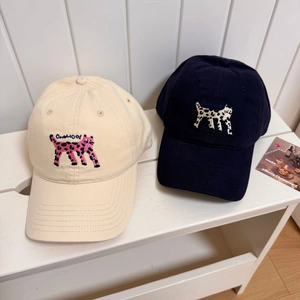 Beige and navy baseball caps with spotted cat embroidery and curved brim style