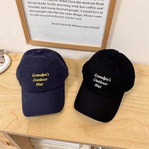Minimalist navy and black baseball caps with Grandpa's Outdoor Hat embroidery on wood