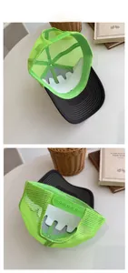 Detail view of neon green mesh trucker hat with black brim and plastic snap closure