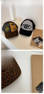 Detail of vintage distressed baseball caps with embroidery and leopard print brim