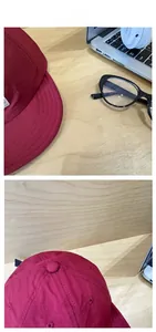 Detail shot of deep red quick-dry baseball cap with reinforced five-row stitching on brim