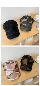 Detail view of four camouflage baseball caps in navy, olive, pink, and brown colorways