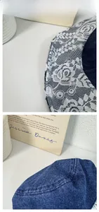 Détail du tissu en jean bleu foncé avec bordure en dentelle blanche florale et coutures