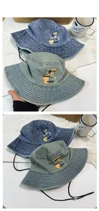 Detailed close-up of bear embroidery and adjustable drawcord on denim bucket hats