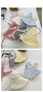 Flat lay of plaid sun hats with lace edges and ribbons in various pastel colors
