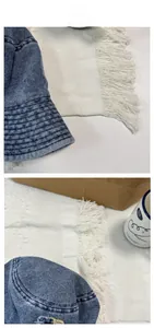 Detailed view of blue washed denim bucket hat with vintage distressed ripped effects