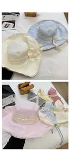 Detailed tile display of plaid wide brim sun hats with lace ribbons and bows