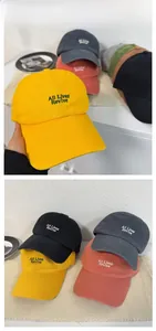 Detail of embroidered 'All Lives Revive' lettering on washed cotton baseball caps