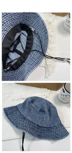 Detail view of denim bucket hat lining with adjustable black windproof chin strap