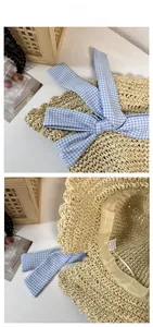 Detailed view of the woven straw hat with a blue gingham bow and interior sweatband