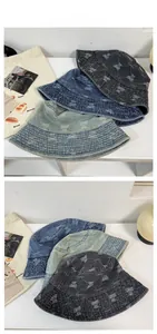 Macro detail of washed denim bucket hats with bear jacquard and embroidery stitching