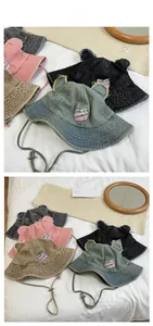 Detail of denim bucket hats with cute bear ears and adjustable windproof straps