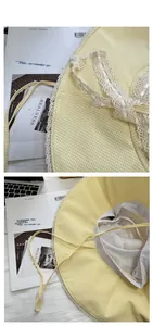 Detail of yellow gingham sun hat featuring white lace trim and adjustable drawstring