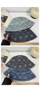 Detail of vintage washed denim bucket hats with bear prints in light blue and grey tones