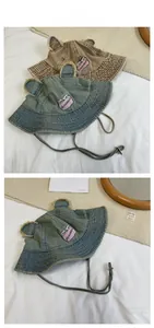 Close-up of vintage denim bucket hat with cute bear ears and adjustable chin strap