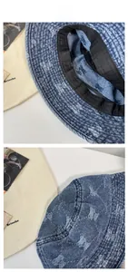 Detail view of washed denim bucket hat with light blue bear pattern and black sweatband inside