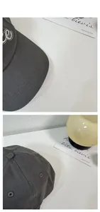 Vista dettagliata del cappellino in cotone grigio scuro con ricamo di lettere bianche in 3D
