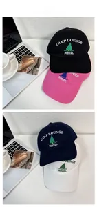 Detail display of cotton baseball caps with pine embroidery and CAMP LOUNGE lettering