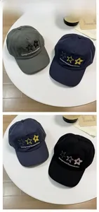 Detailed close-up of embroidered stars and text on three colors of cotton baseball caps