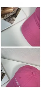 Detail of rose red cotton baseball cap featuring white CAMP embroidery and 6-panel design