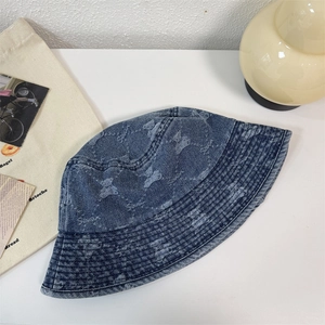 Vintage washed blue denim bucket hat with distressed bear patterns and embroidery detail