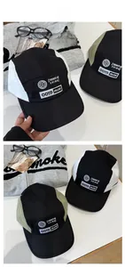 Detail of color-block baseball caps with letter embroidery and contrast stitching