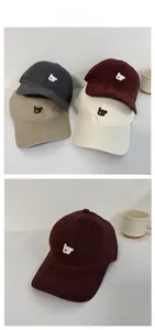 Detailed close-up of cute dog embroidery on various colored cotton baseball caps