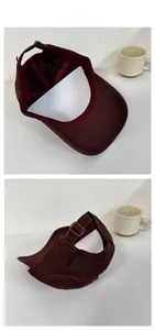 Detail view of burgundy corduroy baseball cap with vintage metal adjustable buckle strap