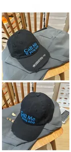 Detail of distressed black cotton cap with blue embroidery and numeric brim stitching