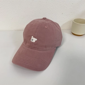 Pink washed cotton baseball cap featuring a white cartoon dog embroidery and soft crown