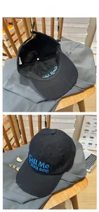 Detailed macro view of black distressed cotton baseball cap with blue letter embroidery