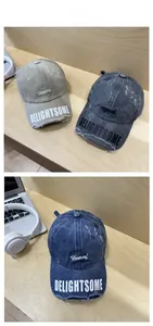 Detail of vintage distressed baseball caps with embroidery on washed cotton canvas